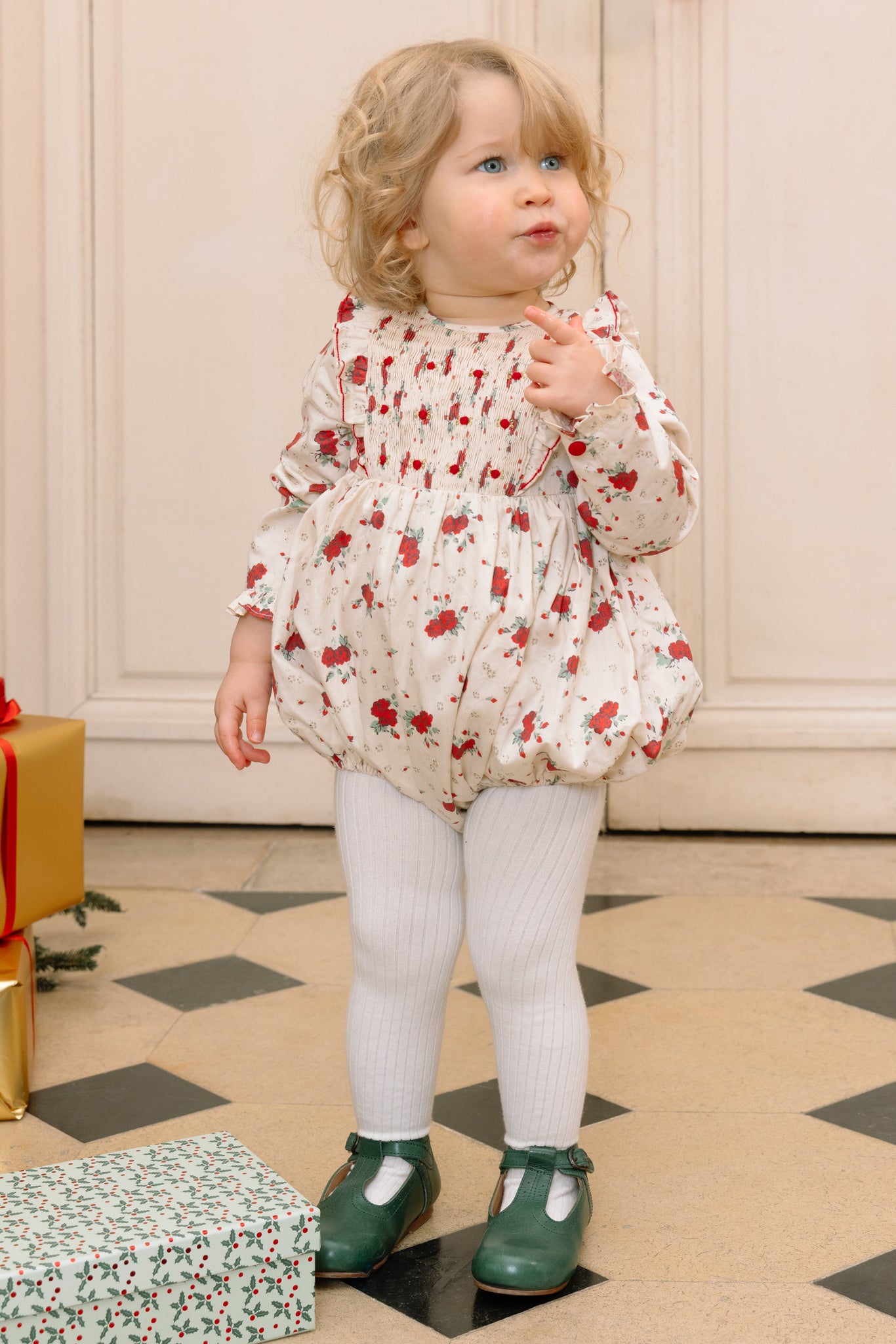 Child wearing Anastasia Christmas Baby Set in an indoor setting