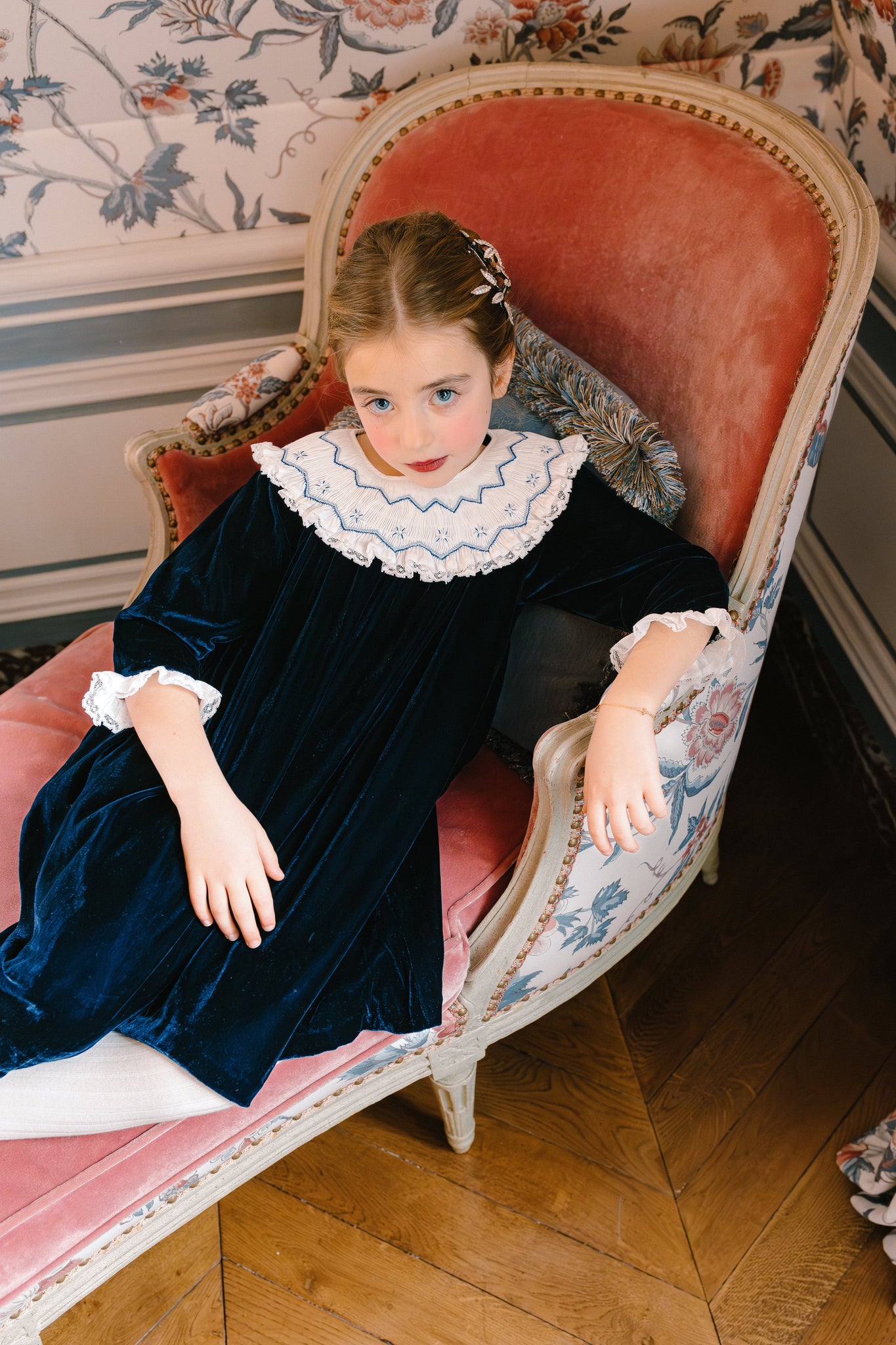 Girl wearing Celeste Navy Velvet Long Sleeve Bishop Dress