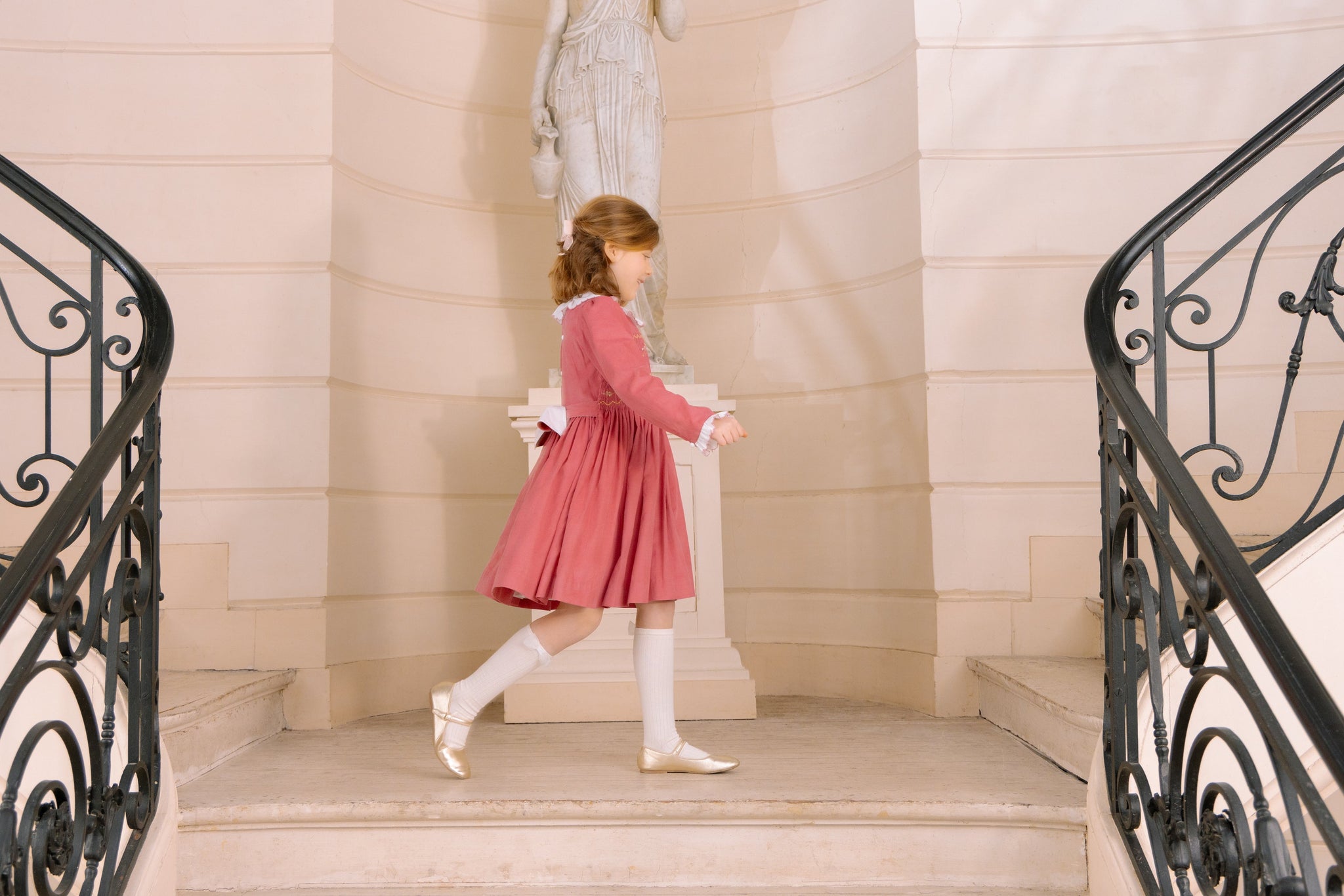 Young girl wearing Chiara Pink Smocked Dress