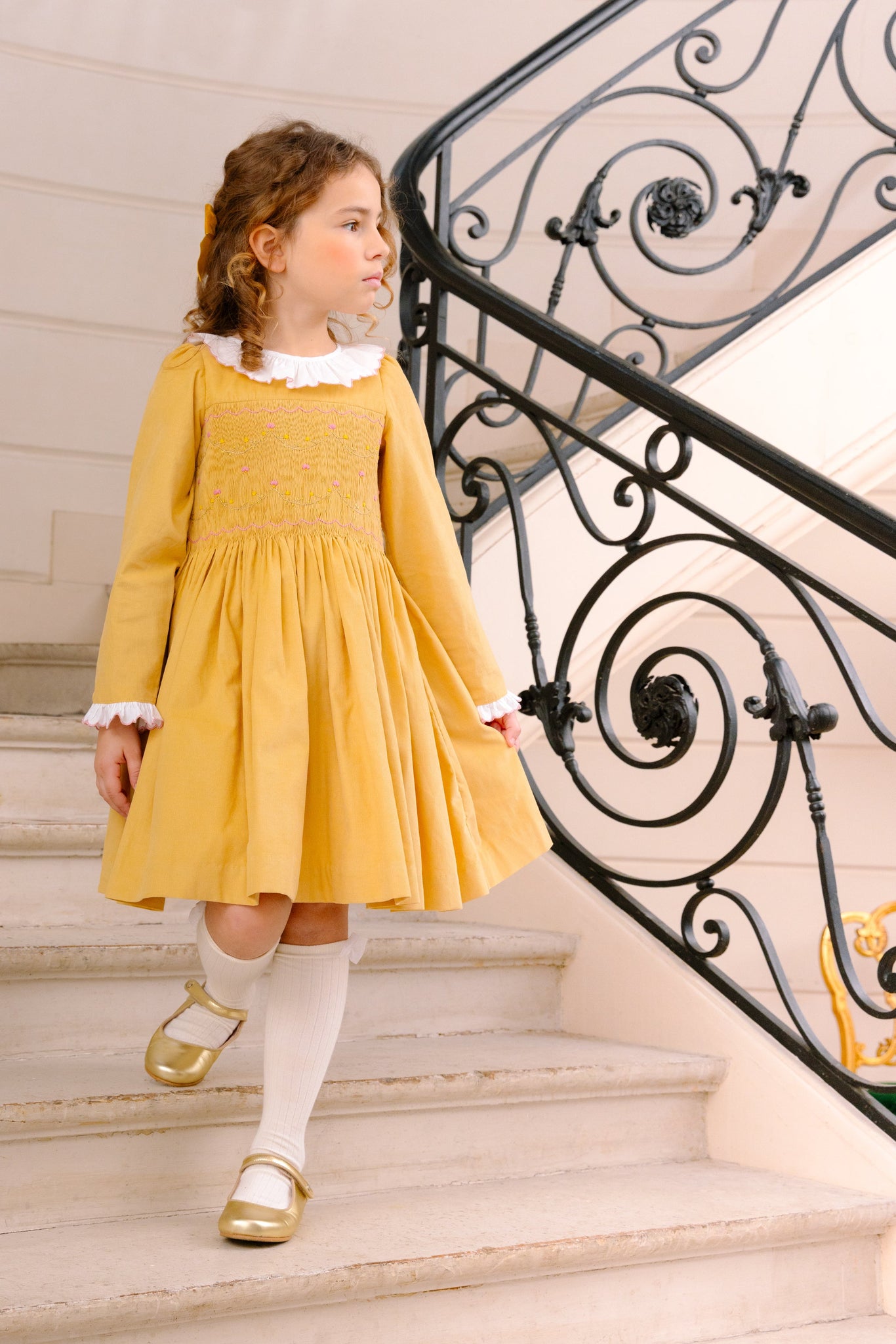Young girl wearing Chiara Yellow Smocked Dress