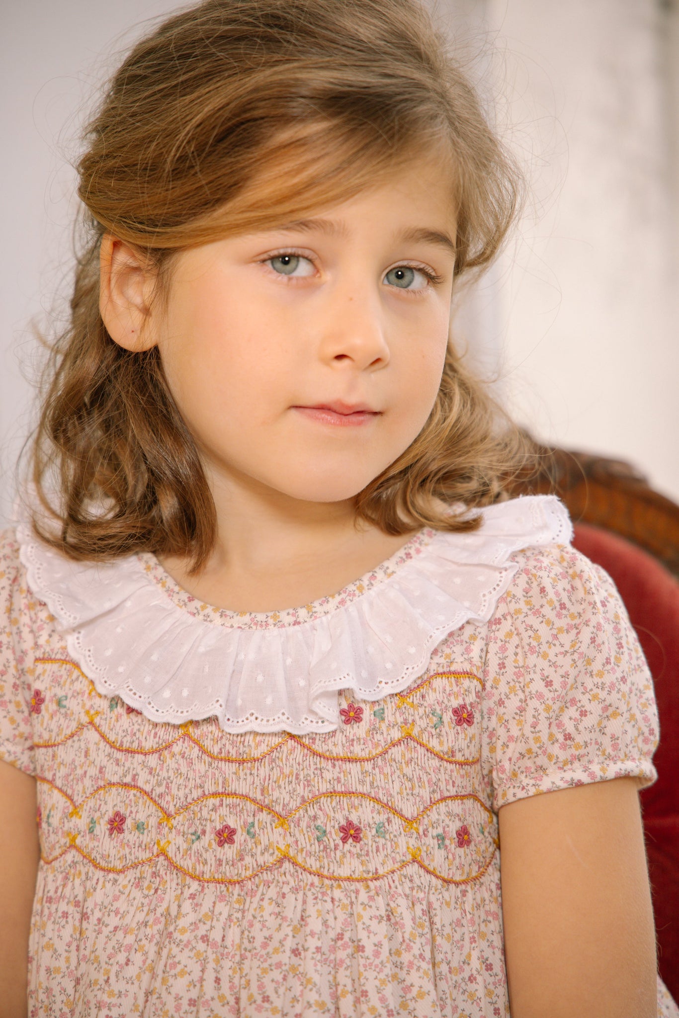 Young girl in Isadora Short Sleeve Floral Smocked Dress