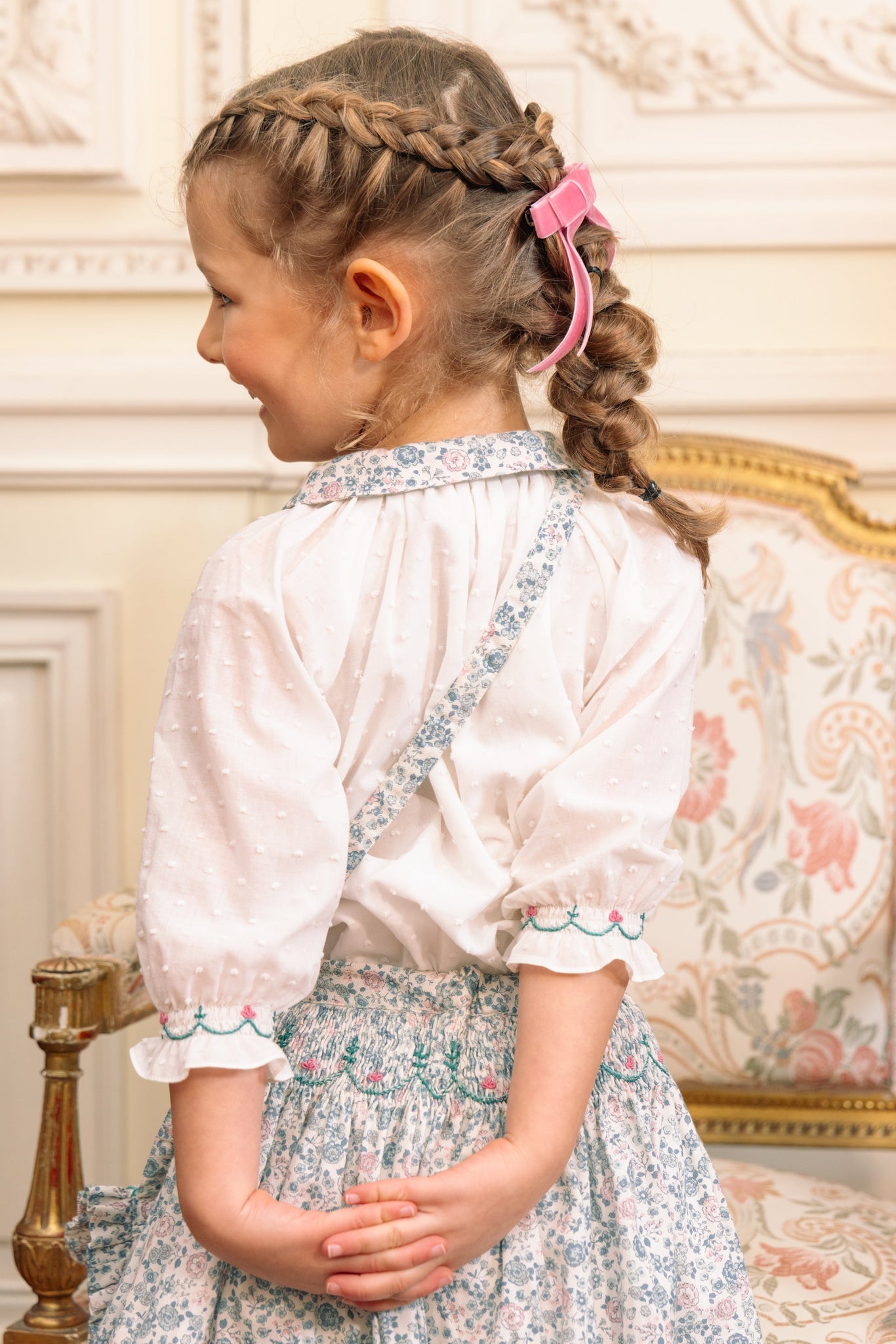 Back of girl wearing Marie Blue Floral Smocked Skirt Blouse Set