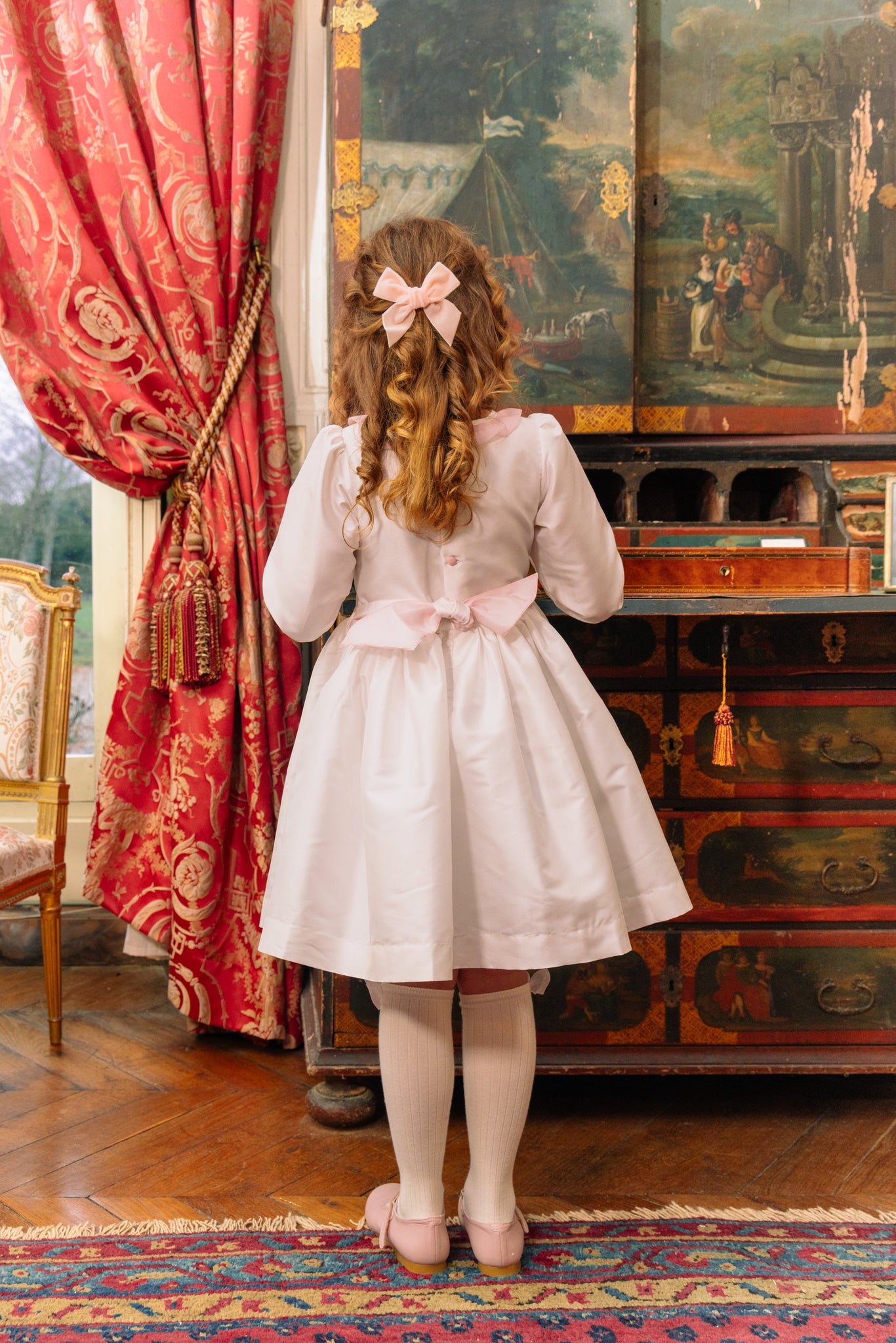 Back of girl wearing Sofia White Taffeta Long Sleeve Smocked Dress